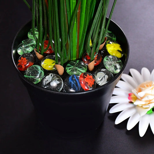 Vibrant multi-color pebbles elegantly arranged in a small plant pot.